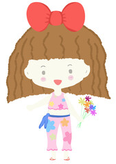 A girl with a red bow stands and holds a flower.