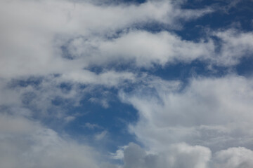 Cloudy sky with white clouds and a cloudless area with blue sky