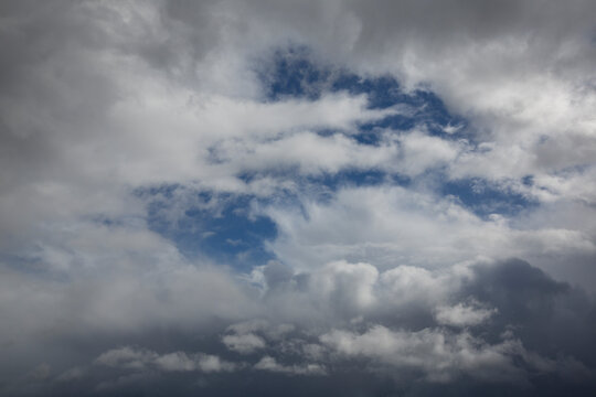 Cloudy sky with white clouds and a cloudless area with blue sky