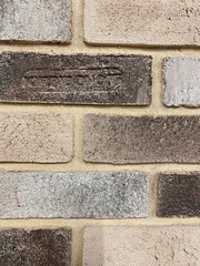 The wall is lined with decorative stone, beautiful seams, background. For the facade of the house, fence