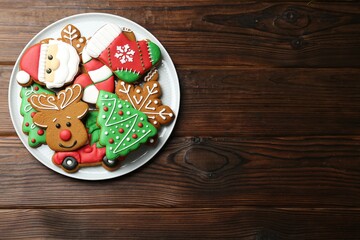 Different tasty Christmas cookies on wooden table, top view. Space for text