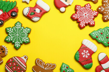 Different tasty Christmas cookies on yellow background, flat lay. Space for text