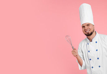 Happy professional confectioner in uniform holding whisk on pink background. Space for text