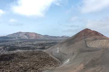 Small volcanoes among black lava field, Timanfaya National park, Lanzarote, Canary islands