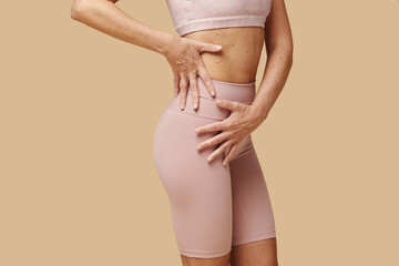 Cropped image of woman showing off her toned and tight thighs and butt
