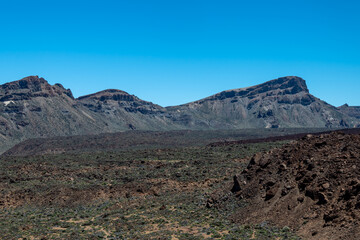 View of Guajara mountain and the caldera ridge in behind the lava field, Teide National Park, Tenerife, Spain