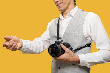 Young photographer getting payment for photo session on yellow background, harmonious blend of...