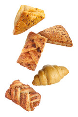 Different tasty puff pastries falling on white background