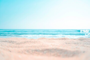 Fototapeta na wymiar Beautiful summer background with a sandy beach and blue sea water, close up and blurred, copy space concept. Summer vacation banner template design for travel or decoration background