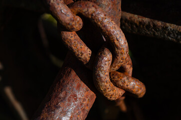 Close up of a rusted chain securing an old machine for safety reasons