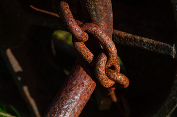 Close up of a rusted chain securing an old machine for safety reasons