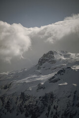 strong south wind and foehn clouds in the alps at a sunny spring day in the national park hohe tauern in austria
