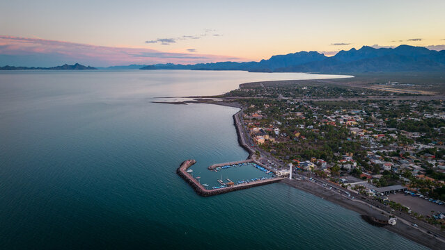 drone fly above Loreto Baja California Sur Mexico old colonial town with sea gulf ocean and mountains desert landscape at sunset