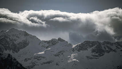 strong south wind and foehn clouds in the alps at a sunny spring day in the national park hohe...