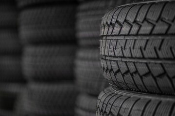 Close-up of rubber tires for the summer or winter season of different thicknesses and diameters on...
