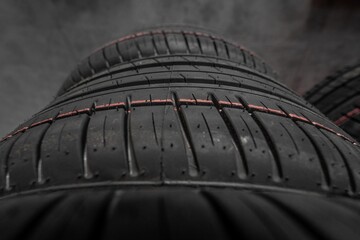 Close-up of rubber tires for the summer or winter season of different thicknesses and diameters on...