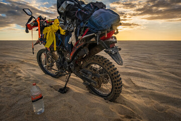 off road adventure motorcycle travel beach desert sunset sand dune backpack 