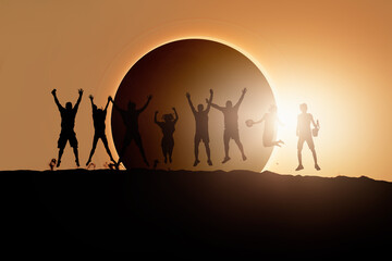 Silhouette of friends jumping at Solar Eclipse "Elements of this image furnished by NASA "