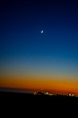 Obraz premium Sunset, Moon and Evening Sky over Maspalomas on Gran Canary Island Spain.