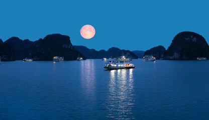 Harbour In Ha long Bay at twilight blue hour with full moon - Ha long bay, Vietnam