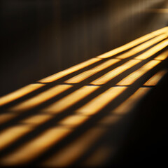 The image is a close up of a wooden bench with a sliver of light shining on it