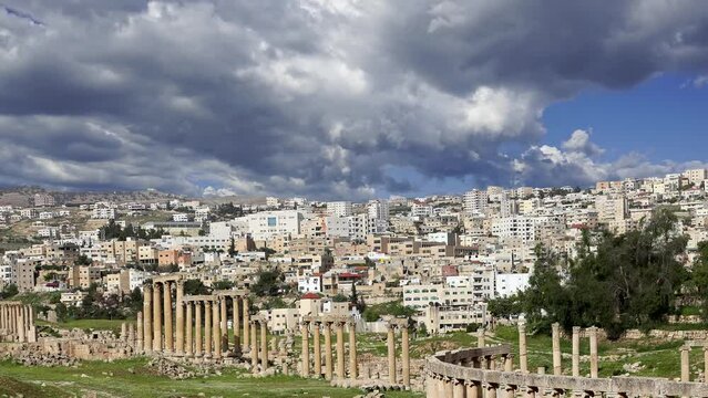 Roman ruins (against the background of a beautiful sky with clouds, 4K, time lapse) in the Jordanian city of Jerash (Gerasa of Antiquity), capital and largest city of Jerash Governorate, Jordan