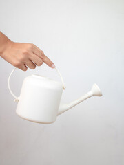 Composition with a watering can in hand. Spring mock up. Gardening concept. Front view.