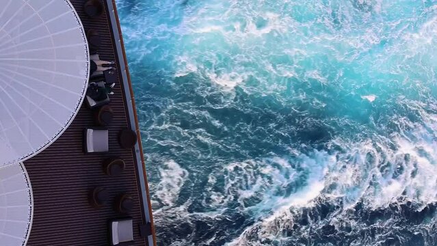 Top view of sea and waves of sailing ship. Lounge promenade deck on cruise liner.