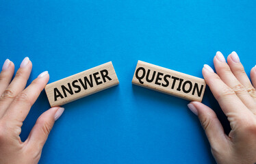 Answer or Question symbol. Concept word Answer or Question on wooden blocks. Businessman hand....