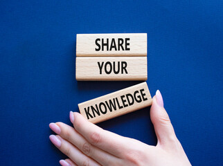 Share your knowledge symbol. Concept word Share your knowledge on wooden blocks. Businessman hand. Beautiful deep blue background. Business and Share your knowledge concept. Copy space