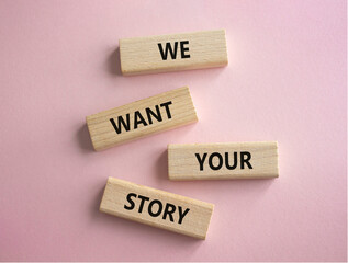 We want your story symbol. Concept words We want your story on wooden blocks. Beautiful pink background. Business and We want your story concept. Copy space.