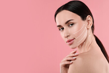 Attractive woman with perfect skin after cosmetic treatment on pink background, space for text. Lifting arrows on her face