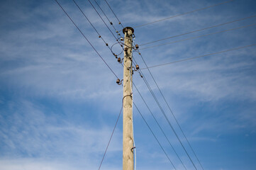 Old style electricity line with old equipment on blue sky background