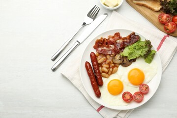 Delicious breakfast with sunny side up eggs served on white table, flat lay. Space for text