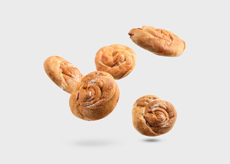 Sweet buns. Delicious rolls with jam falling on light grey background