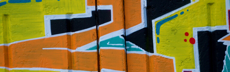 Colorful background of graffiti painting artwork with bright aerosol outlines on wall. Old school...