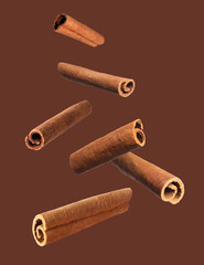 Aromatic dry cinnamon sticks on brown background