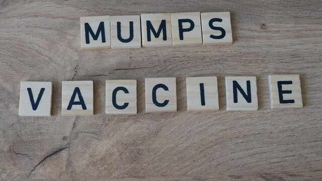 Mumps vaccine concept. Syringe on the table.