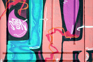 Colorful background of graffiti painting artwork with bright aerosol outlines on wall. Old school street art piece made with aerosol spray paint cans. Contemporary youth culture backdrop