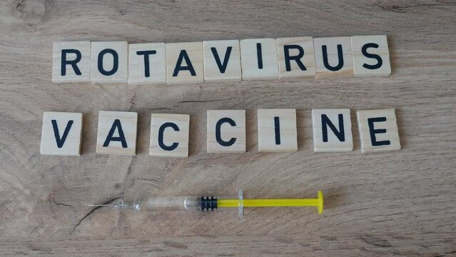 Rotavirus Vaccination concept. Hand in gloves is placing rotavirus word