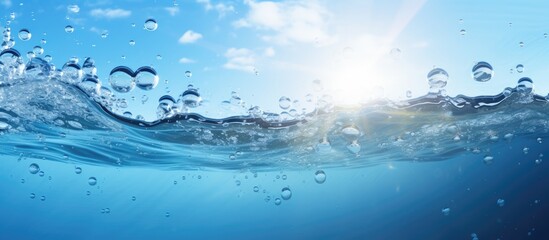 A wave in the ocean with bubbles, sun shining through the water, creating an electric blue natural landscape with cumulus clouds in the sky