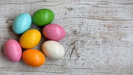 Uova colorate sullo sfondo di legno bianco.