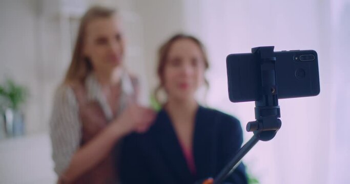 Female influencers vlogging together through smartphone