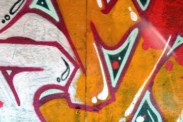 Colorful background of graffiti painting artwork with bright aerosol outlines on wall. Old school...