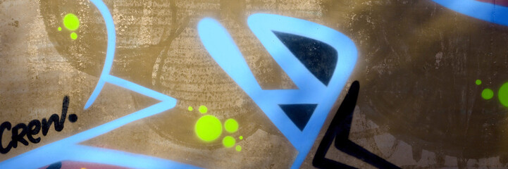 Colorful background of graffiti painting artwork with bright aerosol outlines on wall. Old school...