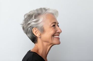 Silver Elegance: Smiling Mature Woman with Stylish Gray Hair in Casual Black Top