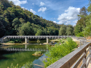 Fototapeta na wymiar Bridge over Korana river canyon and beautiful village of Rastoke near Slunj in Croatia