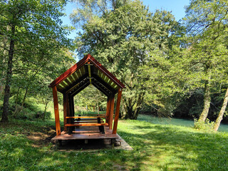 Wooden cabin resort for rest and picnic in the forest by the blue and green river Slunjcica passing...