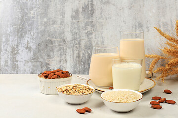 Vegan alternative milk lactose and gluten free, allergy free, almonds, rice, oats and glasses of drinks on the kitchen table, healthy eating concept, diet food, weight loss,