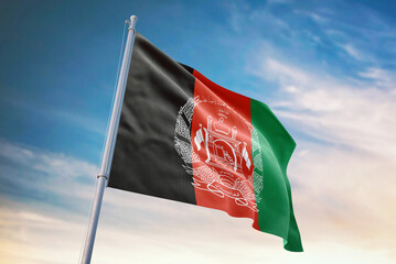 Waving flag of Afghanistan in blue sky. Afghanistan flag for independence day. The symbol of the state on wavy fabric.
